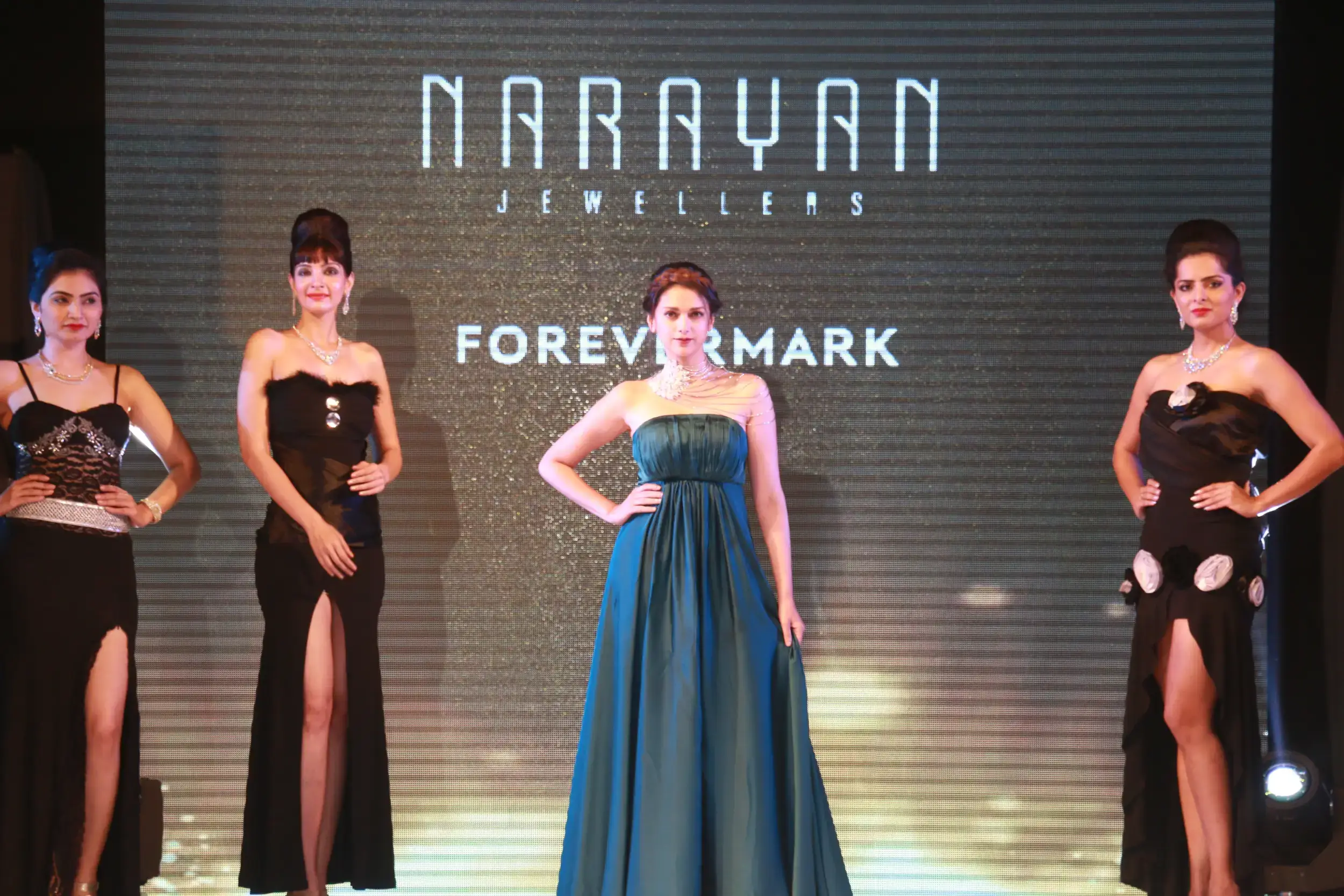 Men lighting ceremonial lamp at event with ITT banner in background